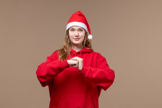 Front view christmas girl with delighted face on a brown background woman holiday christmas