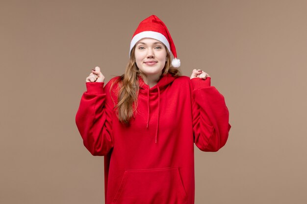 Front view christmas girl with excited face on brown background woman holiday christmas