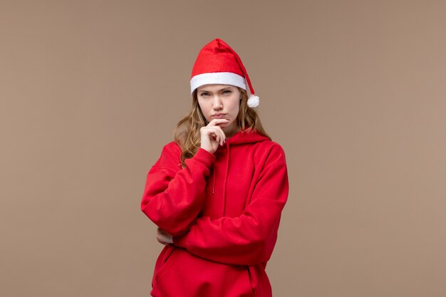 Front view christmas girl with mad face on brown background holiday new year christmas