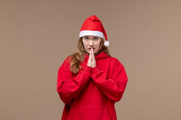 Front view christmas girl with nervous expression on brown space