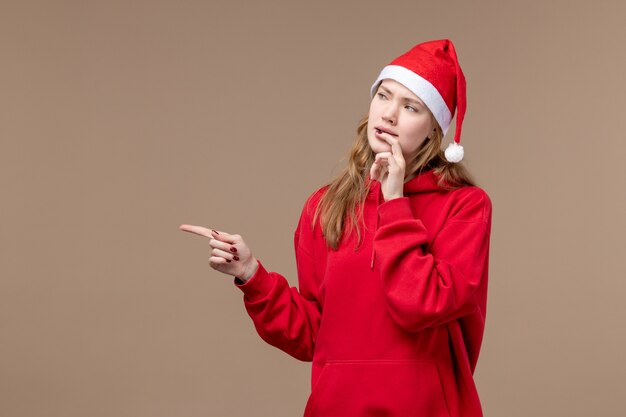 Front view christmas girl with nervous face on brown space