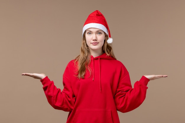 茶色の空間に赤いマントと正面のクリスマスの女の子