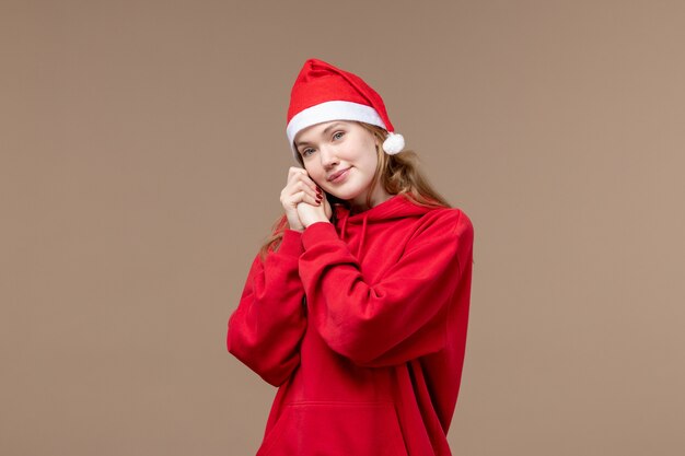 Front view christmas girl with smiling face on brown background holiday christmas emotion