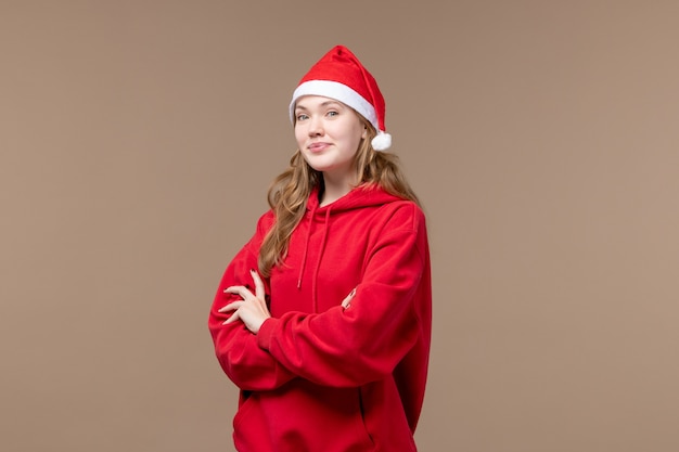 Front view christmas girl with smiling face on the brown background holiday new year christmas