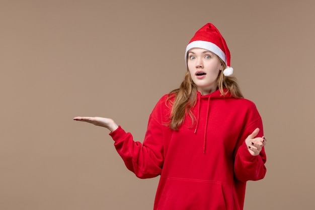 Front view christmas girl with surprised face on brown background holidays new year christmas