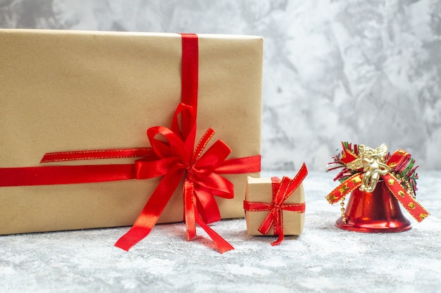 Front view christmas presents packaged with red bow on the white background