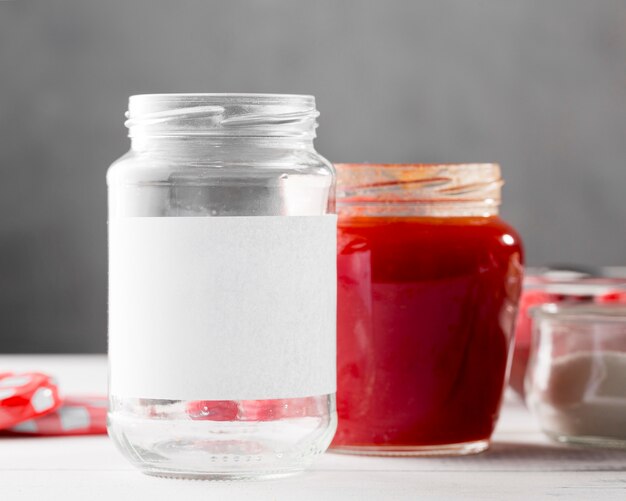 Front view of clear glass jars with raspberry jam