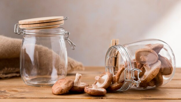 Front view of clear jars with mushrooms