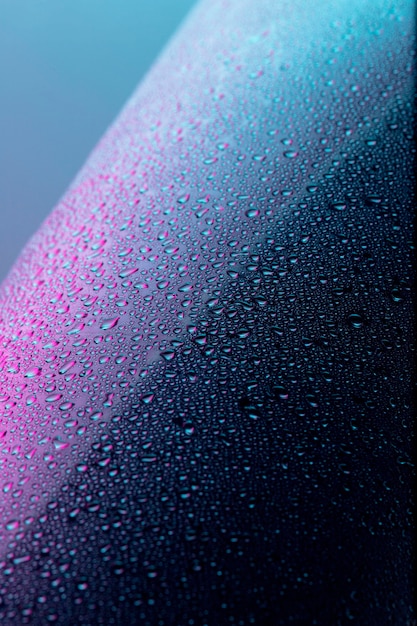 Front view of clear liquid drops on surface