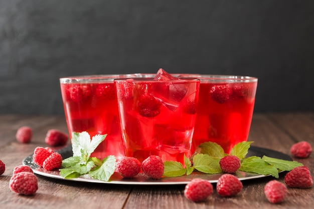 front view of cocktail glasses with mint and raspberries