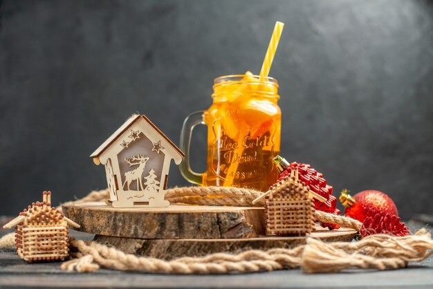 Front view cocktail match house lantern on wood board on dark isolated background