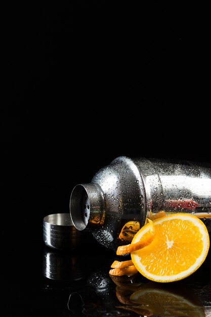 Front view of cocktail shaker with orange and copy space