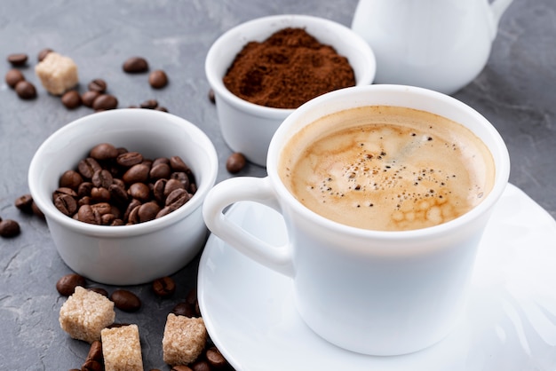 Front view of coffee cup and beans