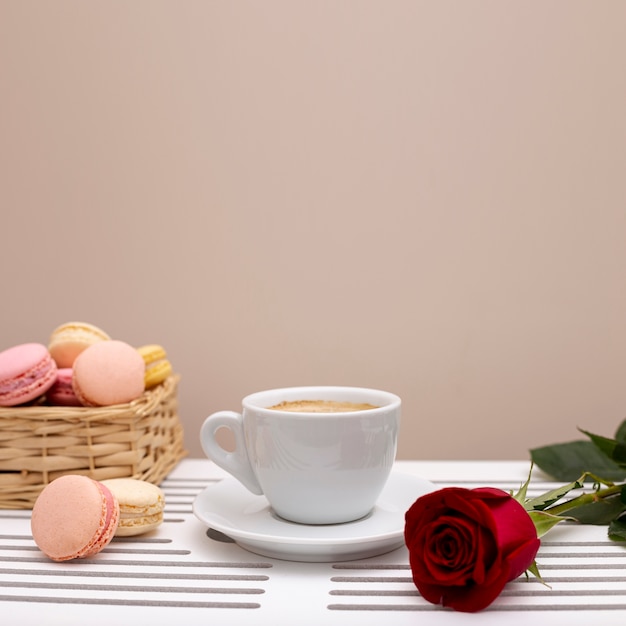 Front view of coffee cup and rose valentines day with copy space