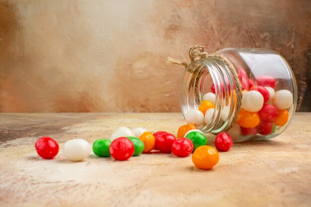 明るい背景のガラス缶の中の正面図カラフルなキャンディー