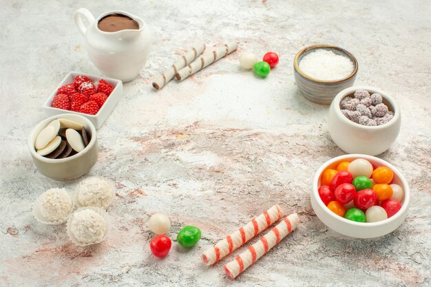 Front view colorful candies with cookies on the white background biscuit sweet cake cookie