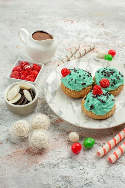 Front view colorful candies with cream cakes on white background biscuit sweet cake cookie sugar