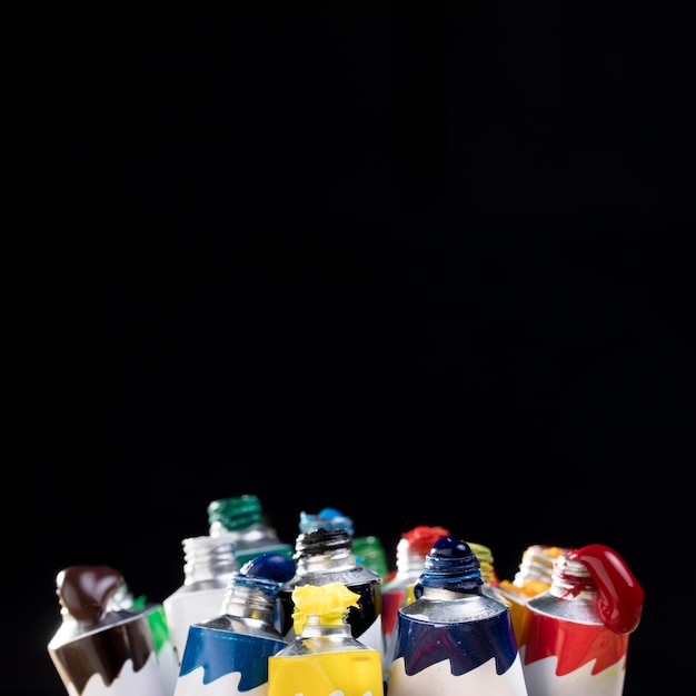 Front view of colorful paint in tubes with copy space