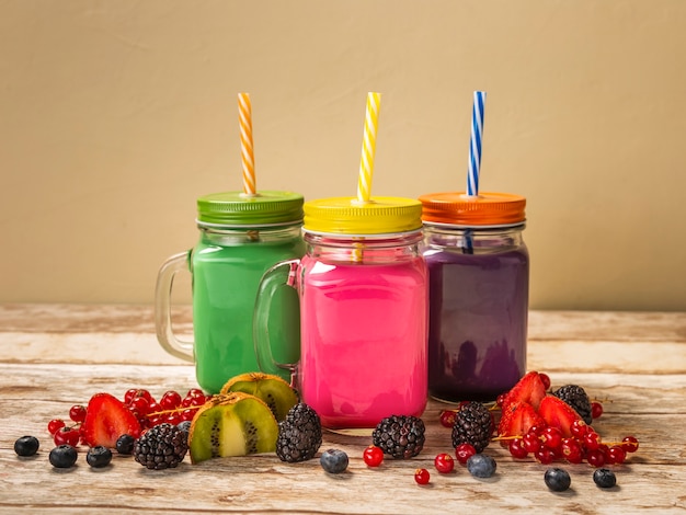 Front view colorful smoothies in jars