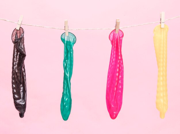 Front view colourful condoms with clothespin