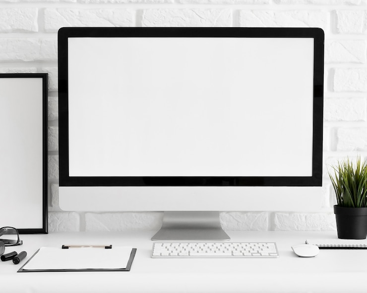 Free Photo front view of computer screen on office workspace with keyboard and clipboard