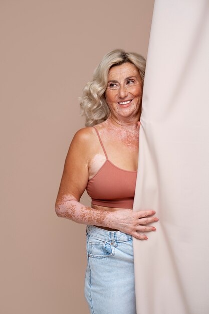 Front view confident old woman posing in studio