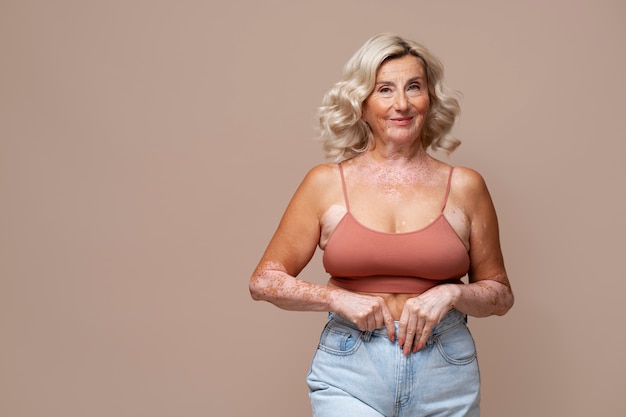 Free photo front view confident old woman posing in studio