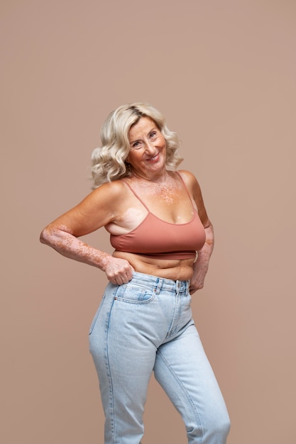 Front view confident old woman posing in studio