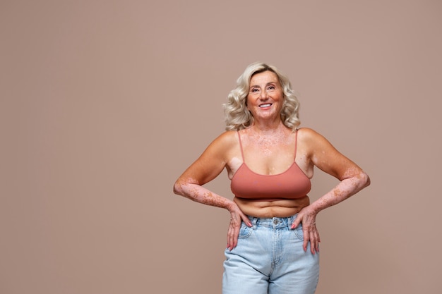 Front view confident old woman posing in studio