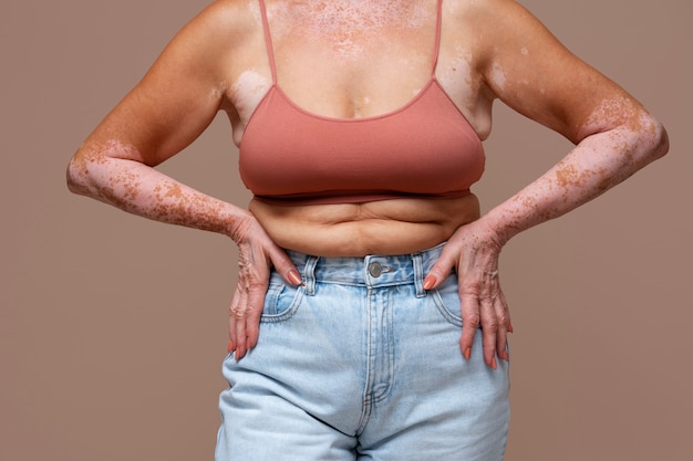 Front view confident old woman posing in studio