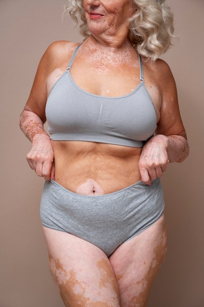 Free photo front view confident old woman posing in underwear