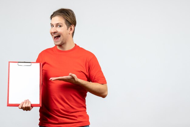 Front view of confident young man in red blouse holding document on white background