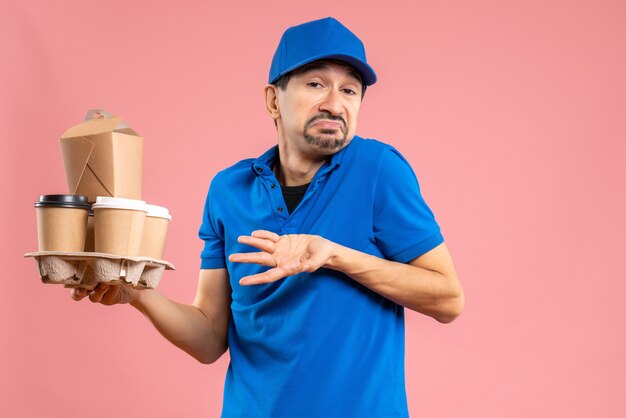 Free photo front view of confused emotional male delivery guy wearing hat holding orders