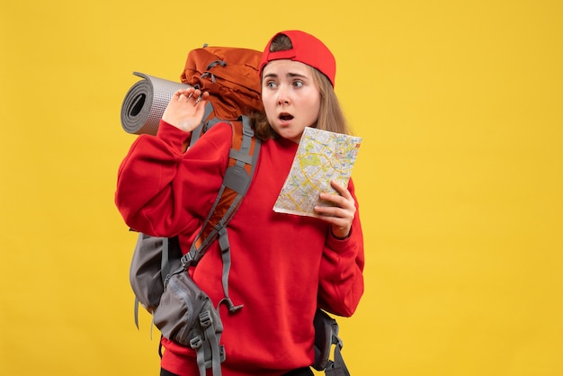 Free photo front view confused girl hiker with red backpack holding map