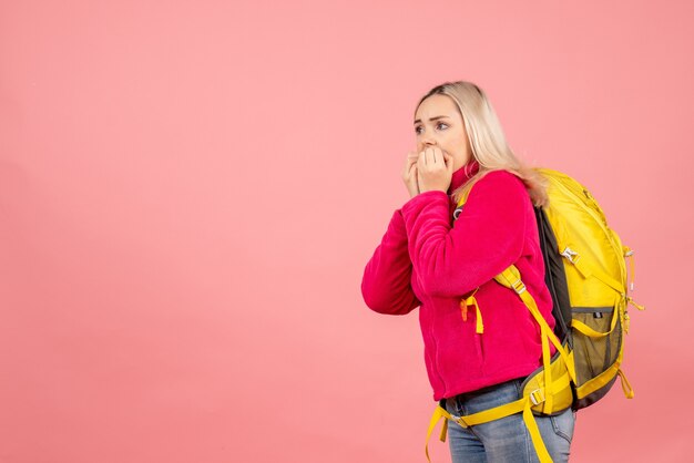 Front view confused traveler woman with backpack