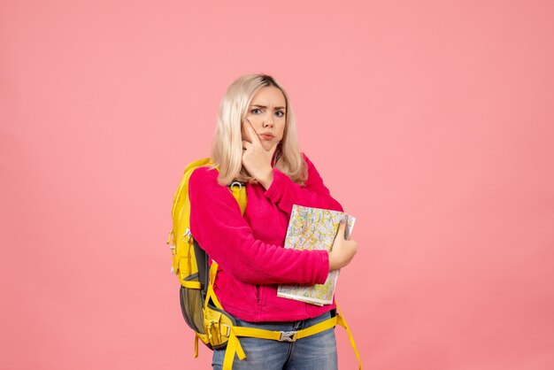 Front view confused traveler woman with yellow backpack holding map