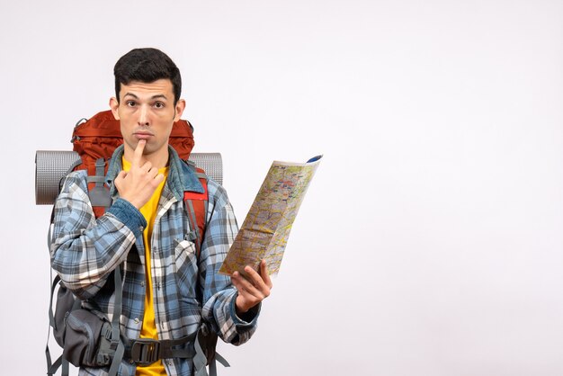 Front view confused young traveller with backpack holding map