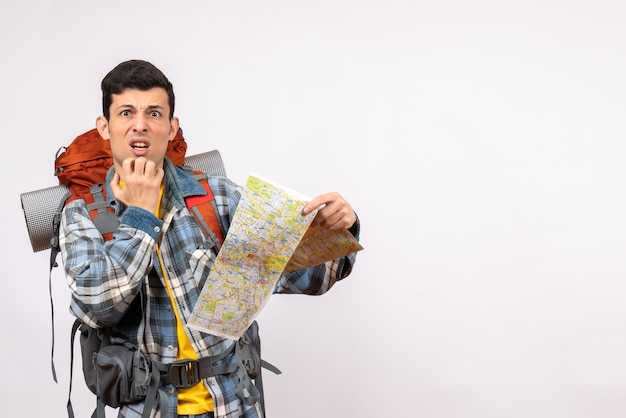 Free photo front view confused young traveller with backpack holding up map