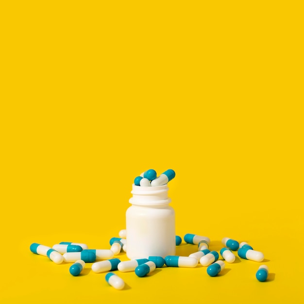 Front view of container with pills and copy space