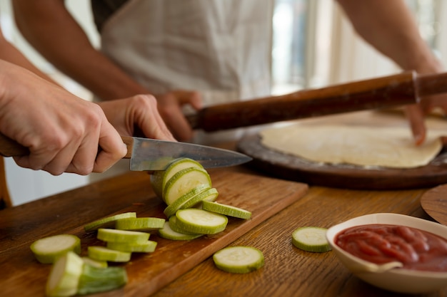 Free photo front view cook preparing pizza