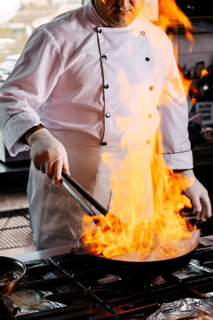 Front view cook preparing round minced meat in the kitchen