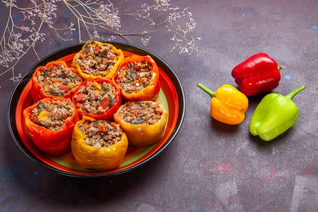 Front view cooked bell-peppers with ground meat on a grey surface meal dolma beef food vegetables meat