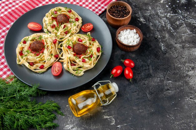 Front view cooked dough slices with meatballs on gray background color pasta meat restaurant dinner cooking dish
