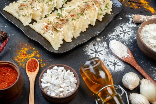 Front view cooked meat dumplings with different ingredients on dark background vegetable dish meal color dough dinner cooking