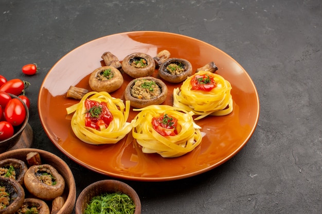 Front view cooked mushrooms with dough pasta on dark desk food meal dish dinner