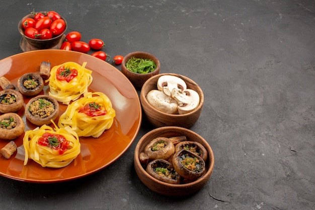 Front view cooked mushrooms with dough pasta on a dark table meal food dinner