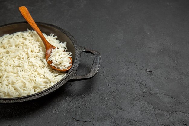 Front view cooked rice inside pan on dark grey surface meal food rice eastern dinner