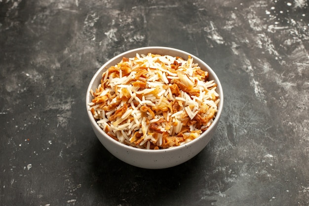 Front view cooked rice inside plate on dark surface dish east meal food dark