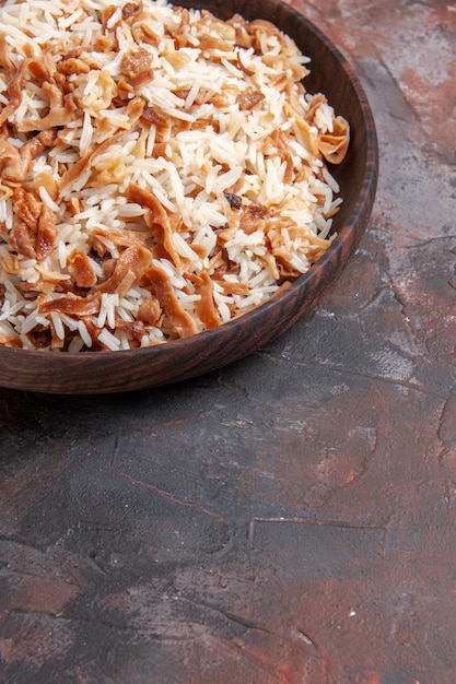 Free photo front view cooked rice with dough slices on the dark surface photo dish meal dark food