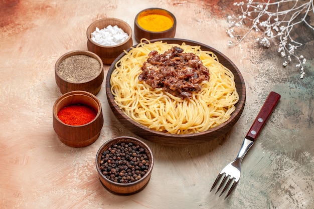 Front view cooked spaghetti with ground meat on the light table pasta dish meal meat